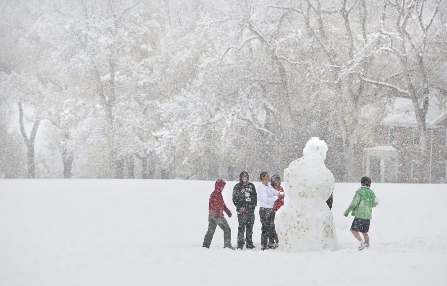 Friends+combine+their+efforts+to+build+a+giant+snowman+during+a+snow+storm+Friday+on+Stilwell+Field+near+student+housing+at+the+University+of+Utah.