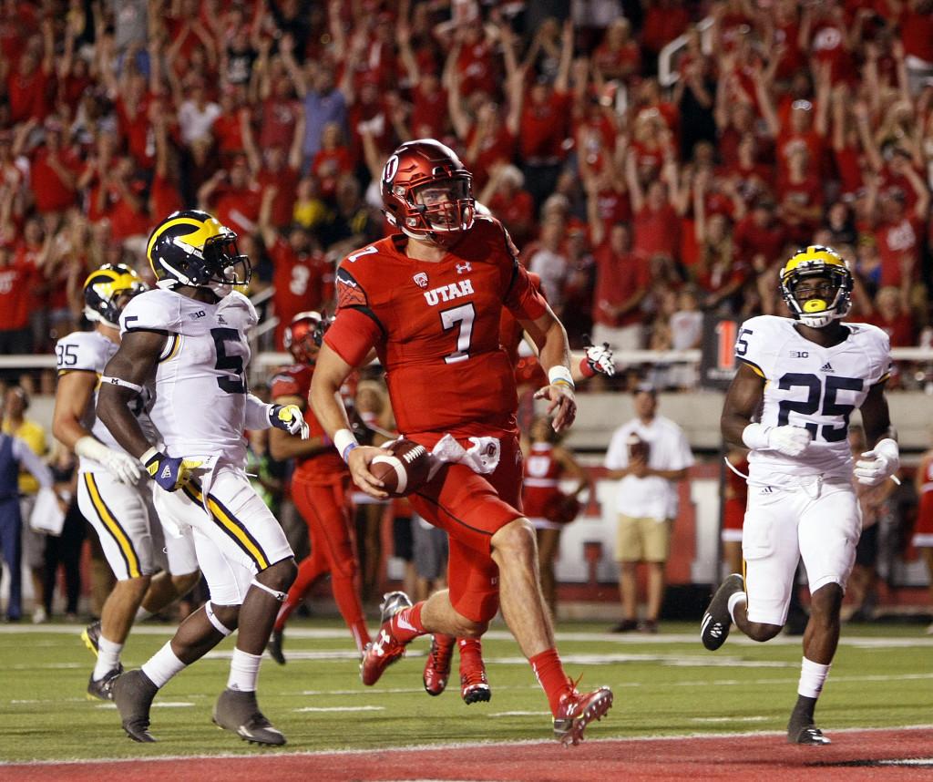 Senior quarterback Travis Wilson (7) runs the ball in for a touchdown in the second half against the Michigan Wolverines at Rice-Eccles Stadium, Thursday, September 3, 2015. Utah won the contest, 24-17. Chris Samuels, Daily Utah Chronicle.