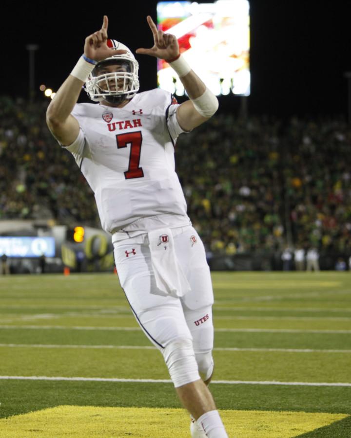 Senior quarterback Travis Wilson, (7), throws up the U sign after running in a touchdown at the Utah Oregon game, Saturday September 26, 2015.