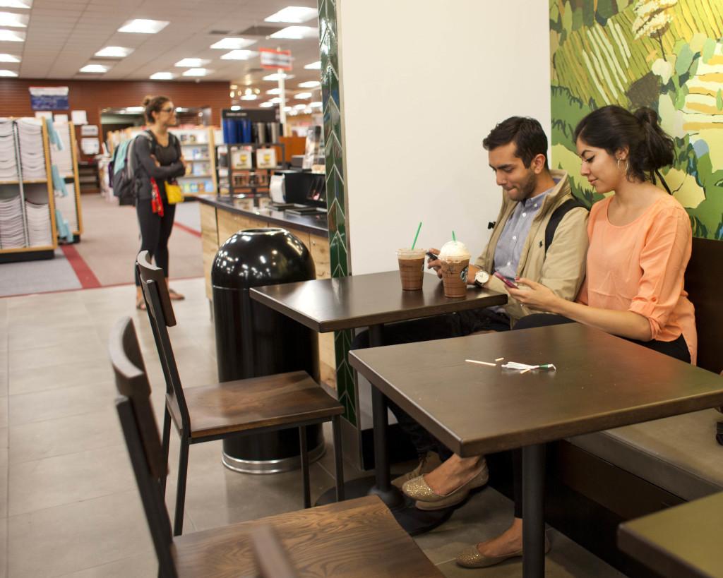 Jimmy Hawatmeh senior biology student and Marlen Olmedo junior political science student enjoy there Starbucks coffee drinks from the new Starbucks in the University campus store, Monday, September 14, 2015.