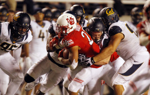 Utah running back Devontae Booker (23) is tackled by multiple Cal Bears defenders during a Pac-12 football game at Rice Eccles Stadium in Salt Lake City, Saturday, Oct. 10, 2015.