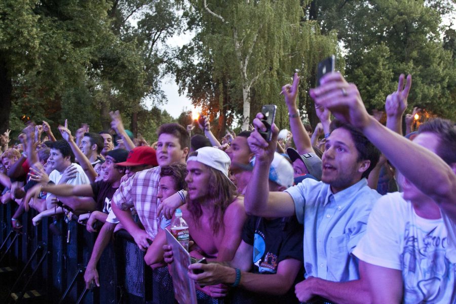 Concert goers cheer and take cell phone photos as Nas comes on stage July 19.