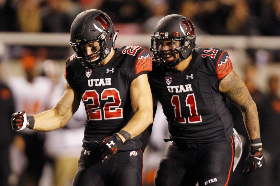 Utah safety Chase Hansen (22) celebrates making a sack with lineman Kylie Fitts (11) during a Pac-12 football game versus the Oregon State Beavers at Rice Eccles Stadium in Salt Lake City, Saturday, Oct. 31, 2015.