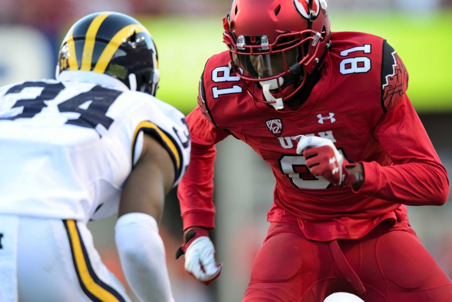 Freshman Tyrone Smith stares down Michigan #34 after the ball was snapped; The Utah Utes beat the Michigan Wolverines 24-17 at Rice Eccles Stadium on Thursday, September 3, 2015