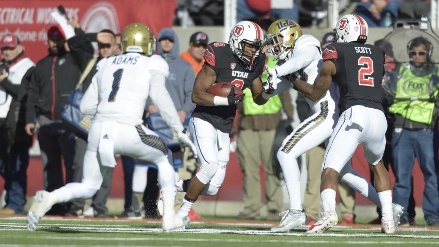 Utah Sr. Bubba Poole (8) runs the ball through UCLA defence in the game at Rice-Eccles Stadium where the UCLA Bruins beat the Utah Utes 17-9 on Saturday, Nov. 21, 2015
