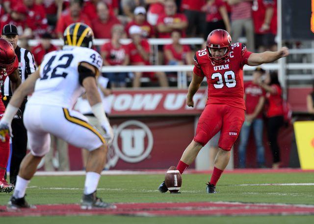 Junior Andy Phillips kicks the ball; The Utah Utes beat the Michigan Wolverines 24-17 at Rice Eccles Stadium on Thursday, September 3, 2015
