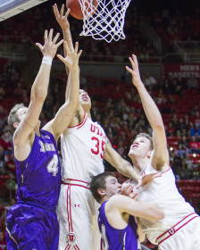 The Runnin' Utes fight for two points at the Utah vs College of Idaho mens basketball game, Monday December 28, 2015.