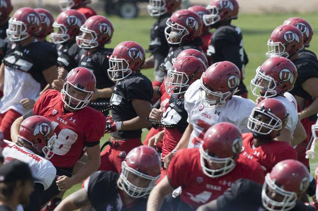 Football players turn as they run sideline sprints at the end of fall practice at the Eccles Football Center, Saturday, August 22, 2015.