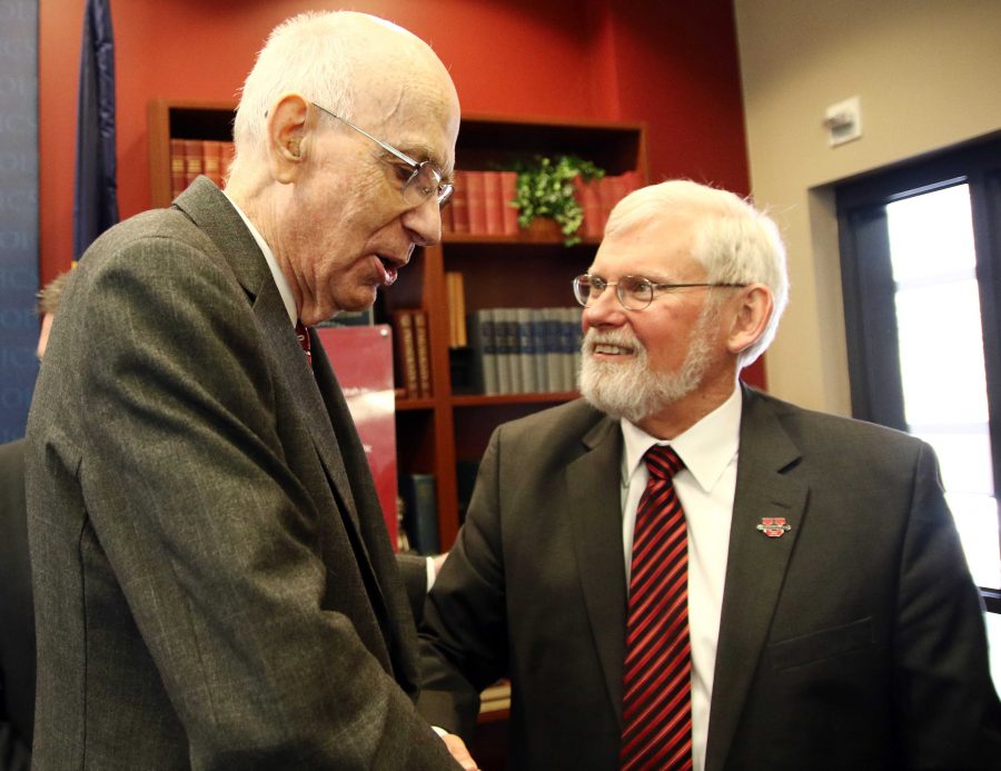 Former U.S. Senator Robert Bennett, left, shakes hands with U President David Pershing during a ceremony to induct senator Bennett into the Hinckley Institute of Politics Hall of Fame in the Hinckley Caucus Room in OSH, Wednesday, Jan. 27, 2016. Chris Samuels, Daily Utah Chronicle.