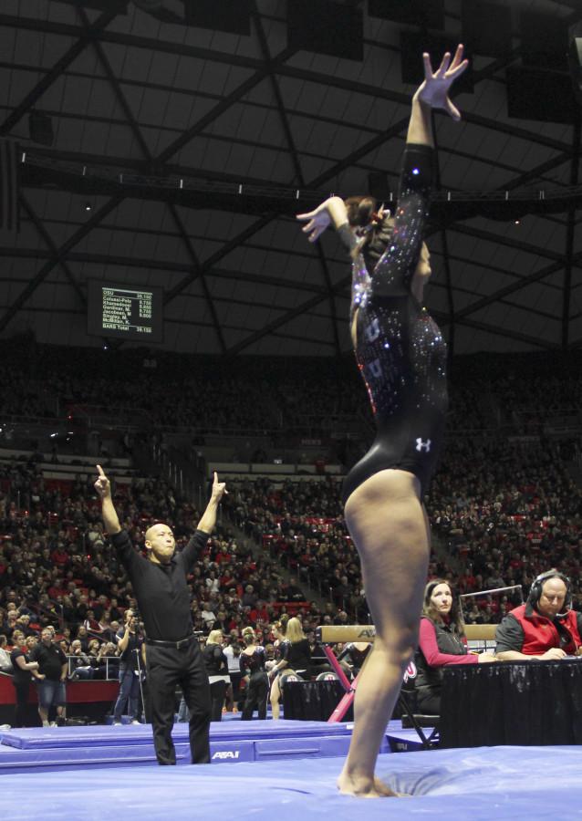 Co-Head Coach Tom Farden, left, celebrates after senior Kailah Delaney completes her vault performance during the Utah v Oregon State gymnastics meet at the Jon M. Huntsman Center, Saturday, Jan. 23, 2016. The Red Rocks won the meet 196.125-195.125. (Madeline Rencher, Daily Utah Chronicle)