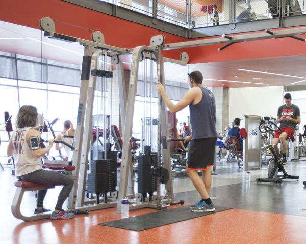 students work the various weight and cardio machines at the Student Life Center, Wednesday January 13, 2016.