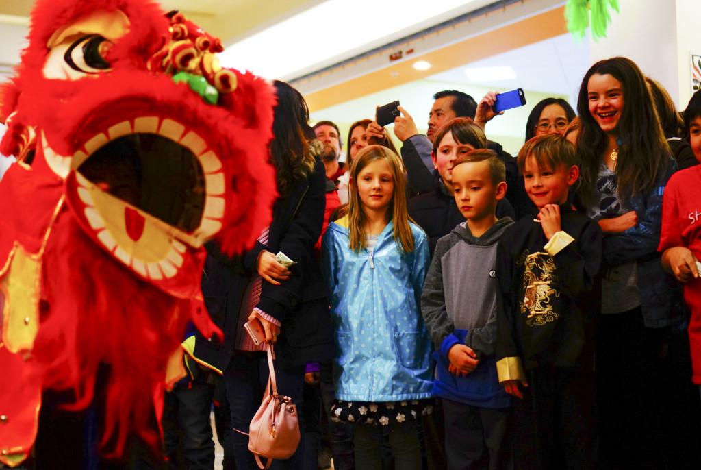 Spectators watch a lion dance at the Chinese New Year Celebration at Chinatown in South Salt Lake City on Saturday, Feb. 9, 2016.  (Rishi Deka, Daily Utah Chronicle)