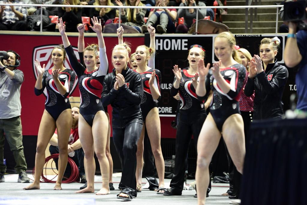 The Red Rocks celebrate after senior Breanna Hughes' beam routine during a meet against the Arizona Wildcats at the Jon M. Huntsman Center on Monday, Feb. 1, 2016. (Kiffer Creveling, Daily Utah Chronicle)