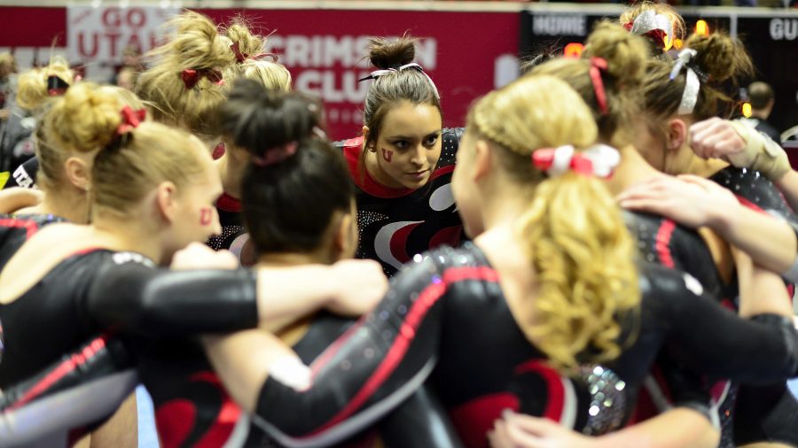 Senior Kailah Delaney listens to her teammates during a huddle in a meet against the Arizona Wildcats at the Jon M. Huntsman Center on Monday, Feb. 1, 2016. (Kiffer Creveling, Daily Utah Chronicle)