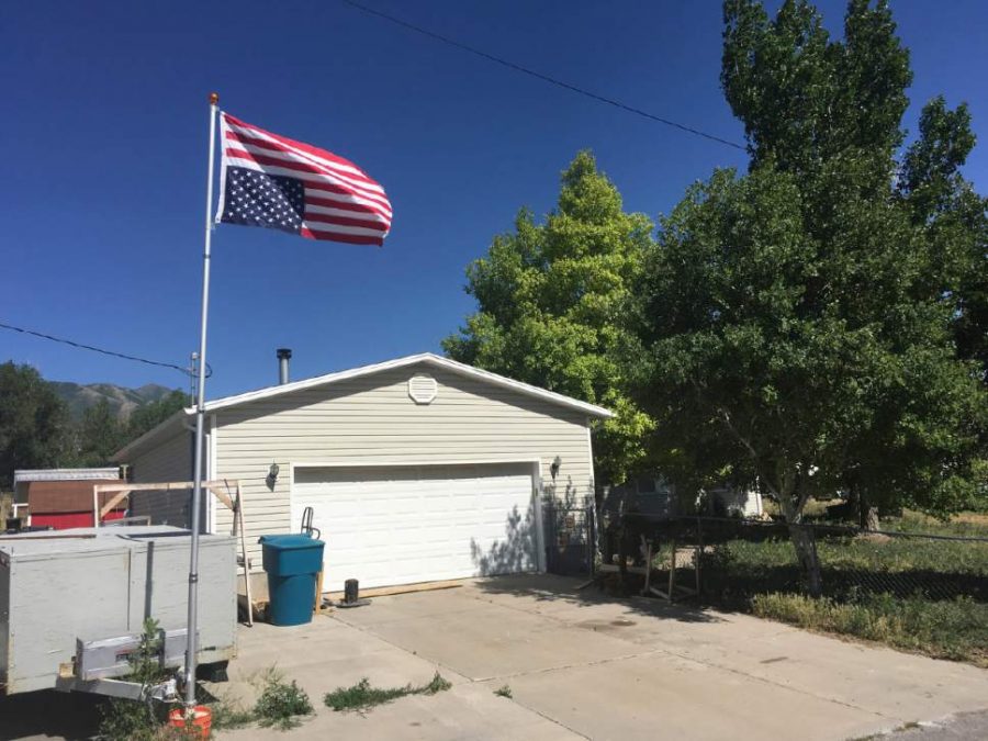 An American flag flies upside down outside William Keeblers residence in Stockton, UT (Matthew Piper, The Salt Lake Tribune)