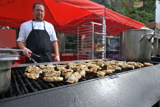 Matthew Seare the executive chef of the Heritage Center grills up chicken at the farmers market.