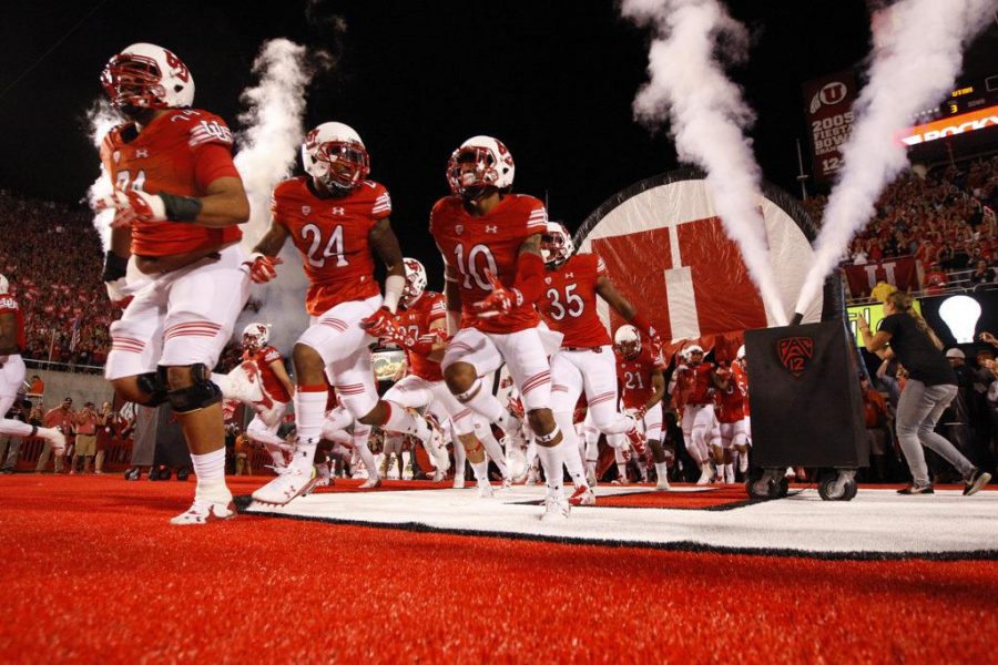 The Utah football team runs into the stadium at the start a Pac-12 football game against the Cal Bears at Rice Eccles Stadium in Salt Lake City, Saturday, Oct. 10, 2015.
