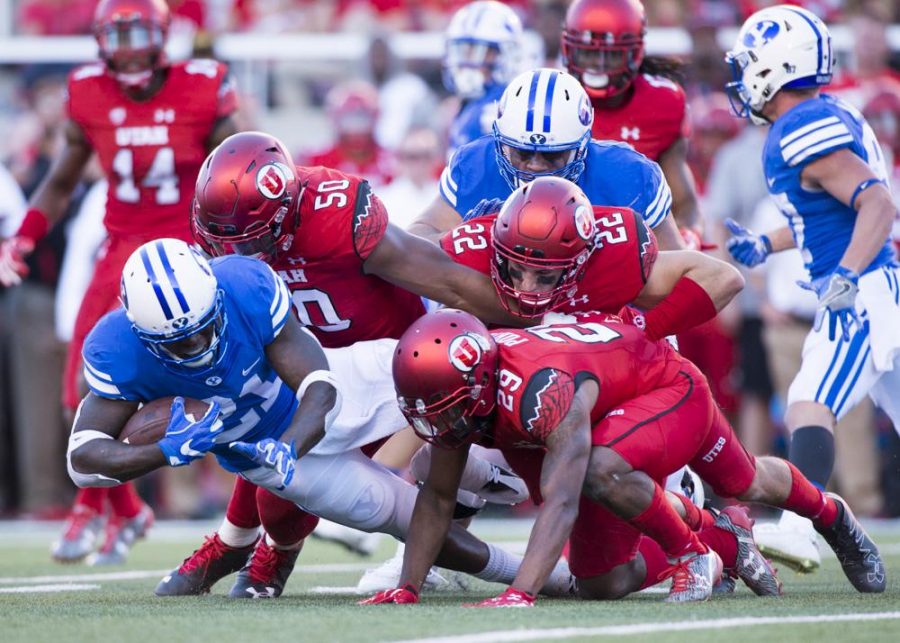 University of Utah Football defense tackles BYU running back Jamaal Willliams (21) during the game vs. the Brigham Young University Cougars at Rice-Eccles Stadium on Saturday, September 10, 2016