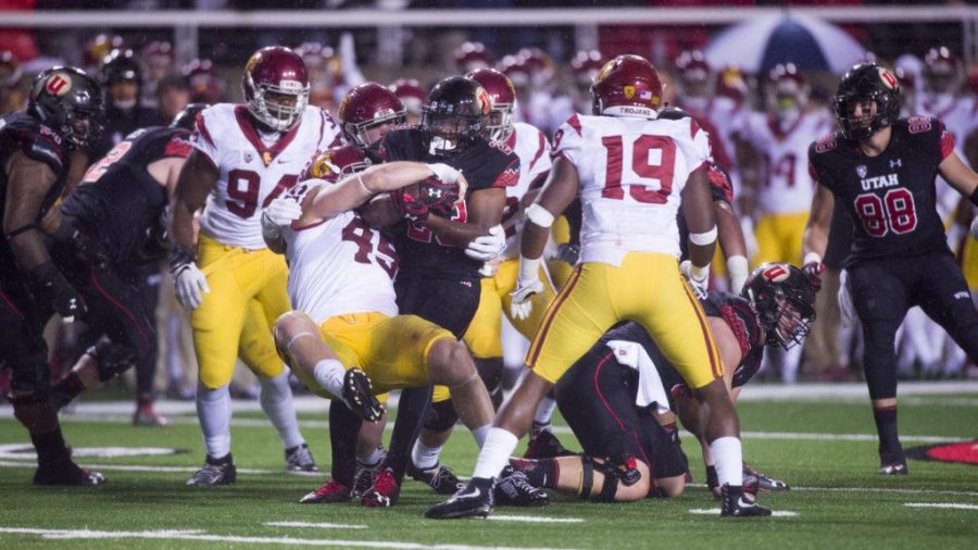 University of Utah Football sophomore running back Armand Shyne (23) gets tackled by USC defense during the game vs. the University of Southern California Trojans at Rice-Eccles Stadium on Friday, September 23, 2016