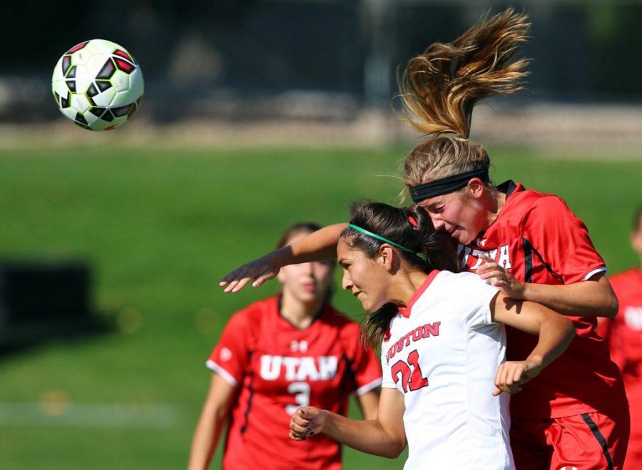 Ffeashman midfielder Max Flom (11) heads the ball away from Houston Cougars sophomore midfielder Vanessa Amaguer (21) at the home opener of Utah soccer at Ute Field, Friday, August 28, 2015.