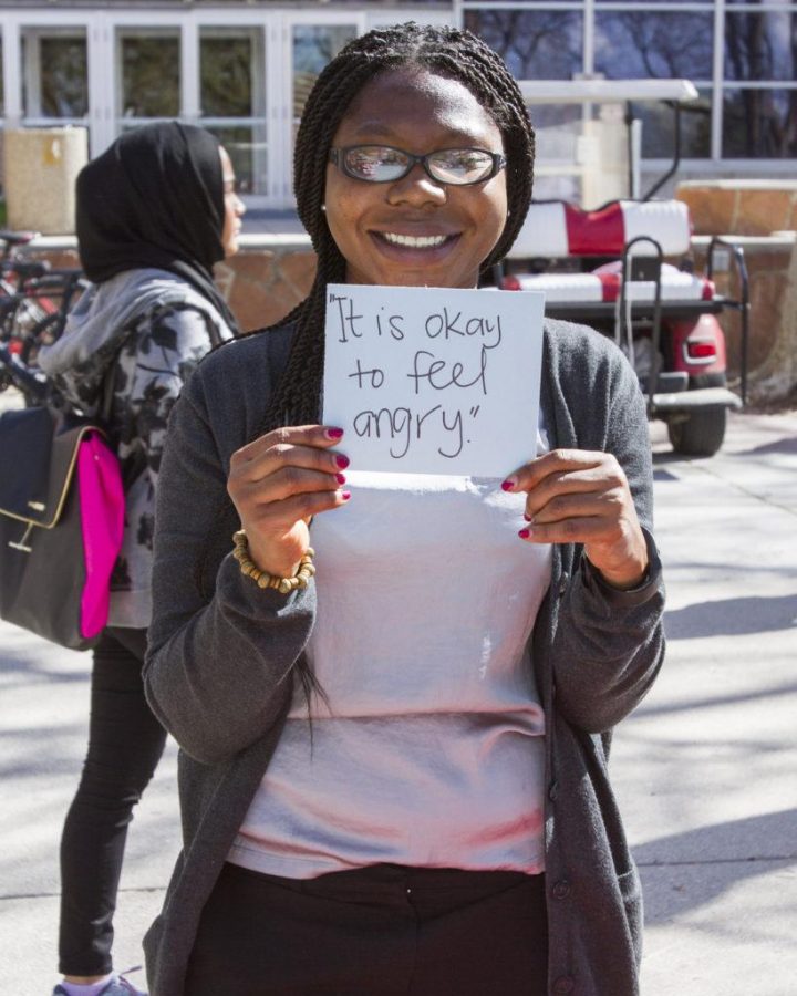 Grad student in health promotion and education, Esther Okang, shows her message on mental health awareness. Monday, April 11, 2016.
