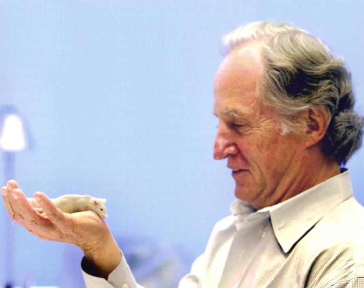 Mario Capecchi with mouse from his lab