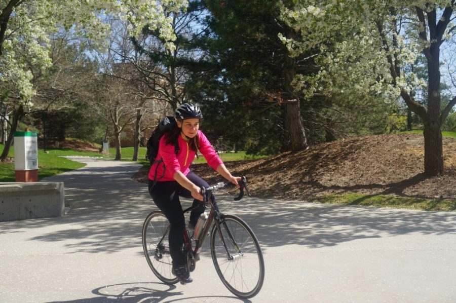 University of Utah faculty and pharmacy student Hillevi Bauer rides her bike near the Merrill Engineering Building at the U in Salt Lake City, Utah on Wednesday, Apr. 12, 2017. (Rishi Deka, Daily Utah Chronicle)