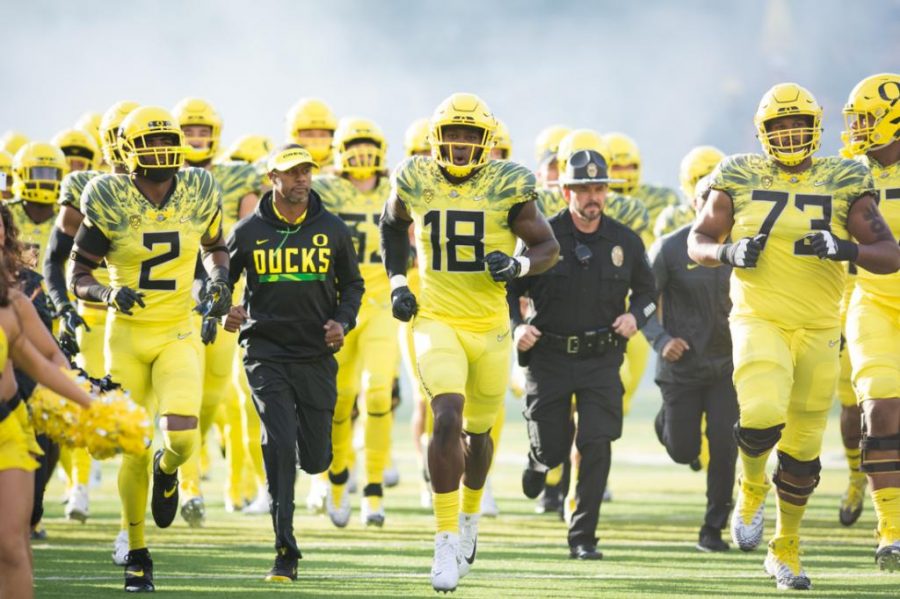 The Oregon Ducks run out with Coach Willie Taggart before the game starts. The Oregon Ducks host the No. 11 Washington State Cougars at Autzen Stadium in Eugene, Ore. on Saturday, Oct. 7, 2017. (Amanda Shigeoka/Emerald)