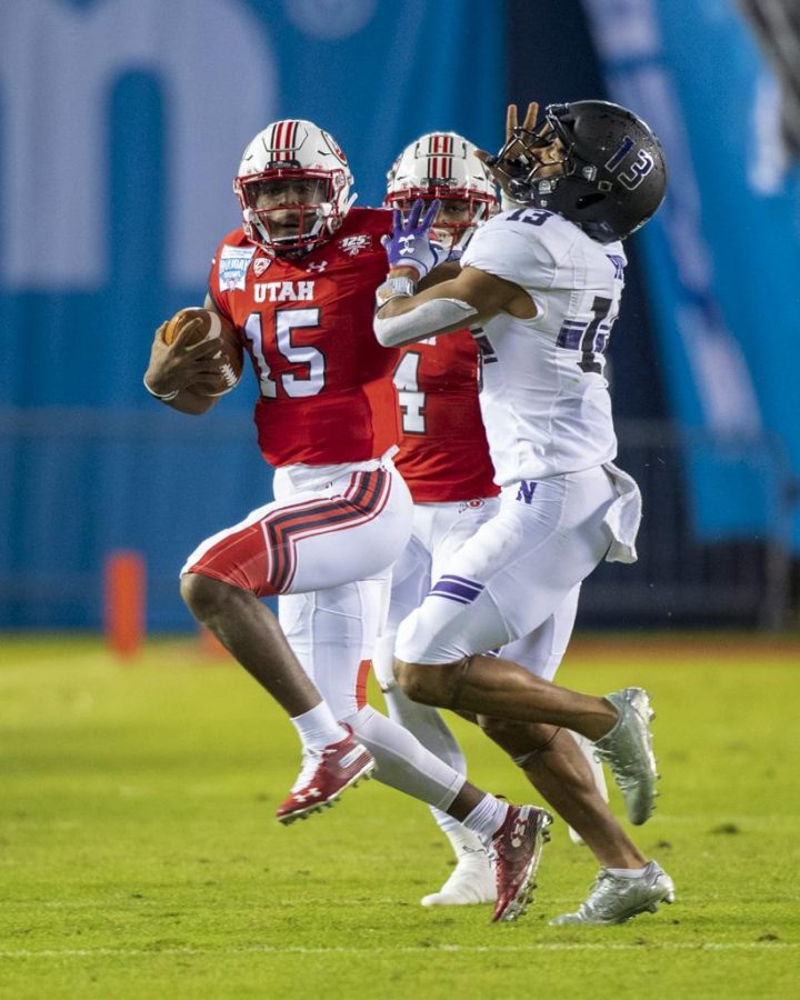 University of Utah freshman quarterback Jason Shelley (15) stiff arms Northwestern University sophomore defensive back JR Pace (13) during the San Diego County Credit Union Holiday Bowl at SDCCU Stadium in San Diego, California on Monday, Dec. 31, 2018. (Photo by Kiffer Creveling | The Daily Utah Chronicle)