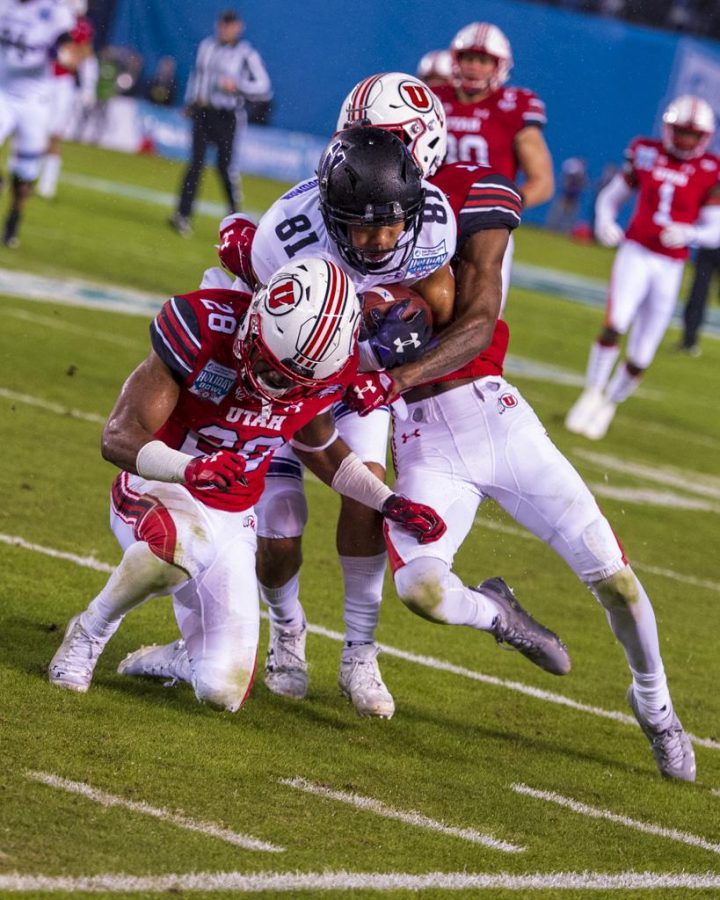Northwestern University senior quarterback Clayton Thorson (18) gets tackled by University of Utah senior defensive back Marquise Blair (13) and Javelin K. Guidry (28) during the San Diego County Credit Union Holiday Bowl at SDCCU Stadium in San Diego, California on Monday, Dec. 31, 2018. (Photo by Kiffer Creveling | The Daily Utah Chronicle)