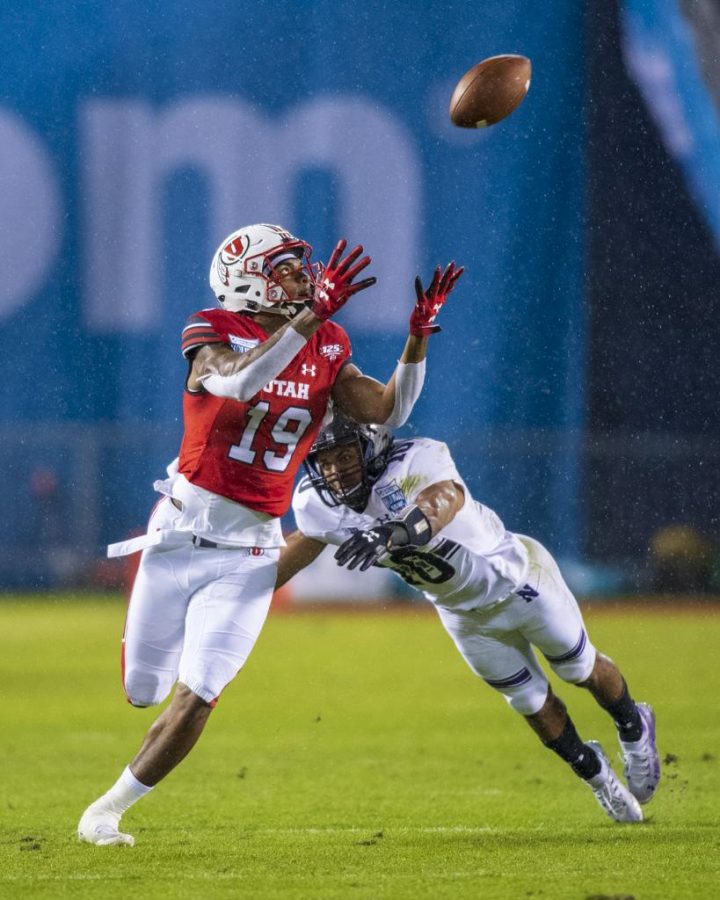 University of Utah sophomore wide receiver Bryan Thompson (19) makes a catch over diving Northwestern University junior defensive back Alonzo Mayo (10) during the San Diego County Credit Union Holiday Bowl at SDCCU Stadium in San Diego, California on Monday, Dec. 31, 2018. (Photo by Kiffer Creveling | The Daily Utah Chronicle)
