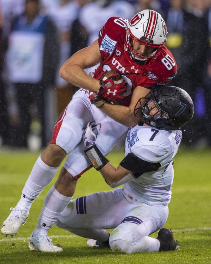 University of Utah freshman tight end Brant Kuithe (80) gets tackled by Northwestern University sophomore defensive back Travis Whillock (7) during the San Diego County Credit Union Holiday Bowl at SDCCU Stadium in San Diego, California on Monday, Dec. 31, 2018. (Photo by Kiffer Creveling | The Daily Utah Chronicle)