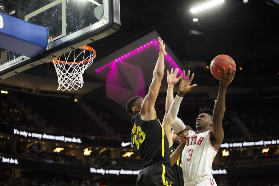 University of Utah sophomore forward Donnie Tillman tries for two over Oregons Francis Okoro in the 2019 Pac-12 basketball tournament quarterfinals. 

(Photo by: Justin Prather | The Daily Utah Chronicle).
