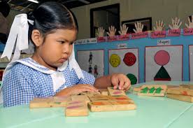 Child plays with blocks, shapes, and colors.