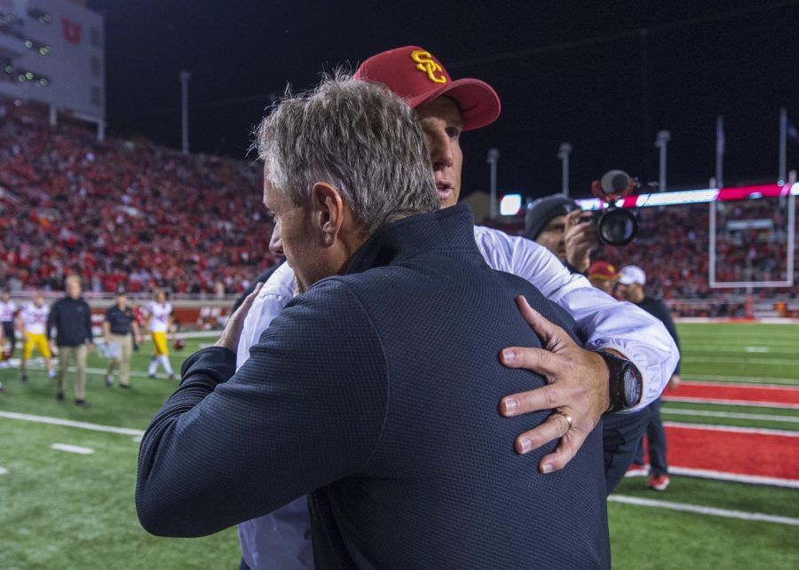 University of Utah football head coach Kyle Whittingham embraces University of Southern California football head coach Clay Helton following an NCAA Football game at Rice Eccles Stadium in Salt Lake City, Utah on Saturday, Oct. 20, 2018. (Photo by Kiffer Creveling | The Daily Utah Chronicle)
