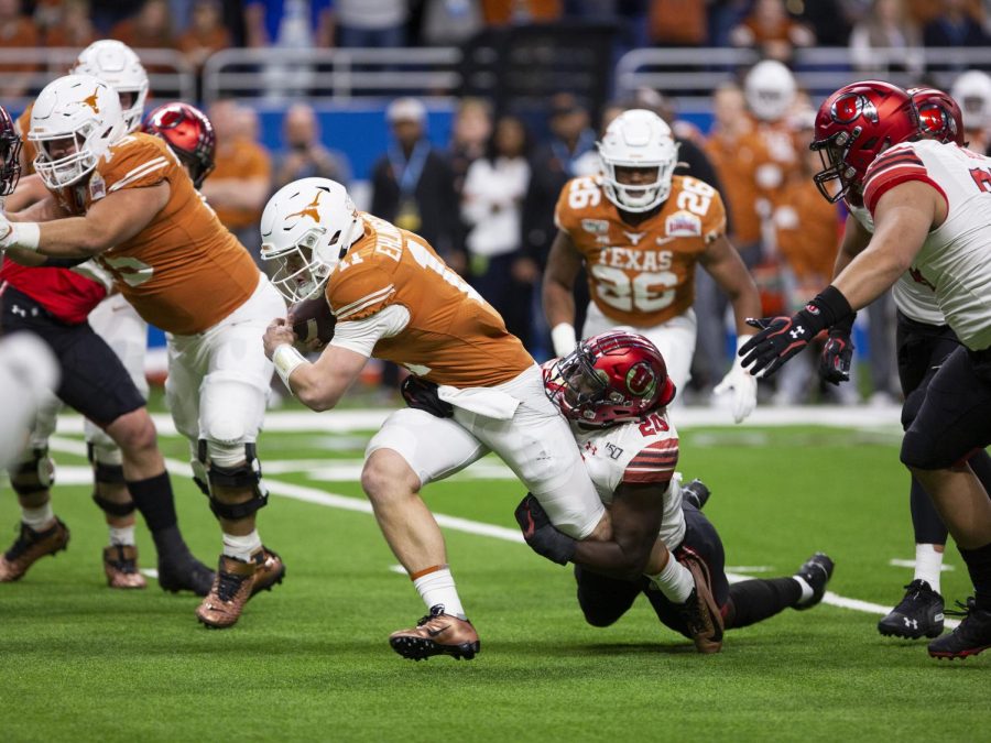 University of Utah sophomore linebacker Devin Lloyd (20) wraps up Texas QB Sam Ehlinger (11) in the Alamo Bowl against the University of Texas Longhorns on Dec. 31, 2019. (Justin Prather | Daily Utah Chronicle)