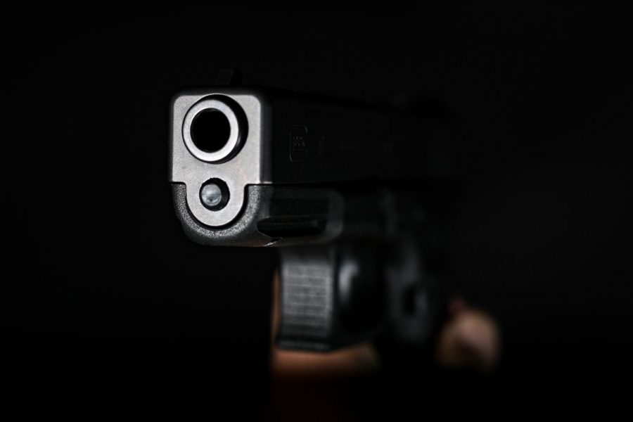 The business end of a Glock 19. Opinion writer KC Ellen Cushman says, If any other cause of death posed as great a threat to public health as gun violence, the Utah legislature would be passing legislation to mitigate the risk. (Photo by: Justin Prather | The Utah Chronicle).
