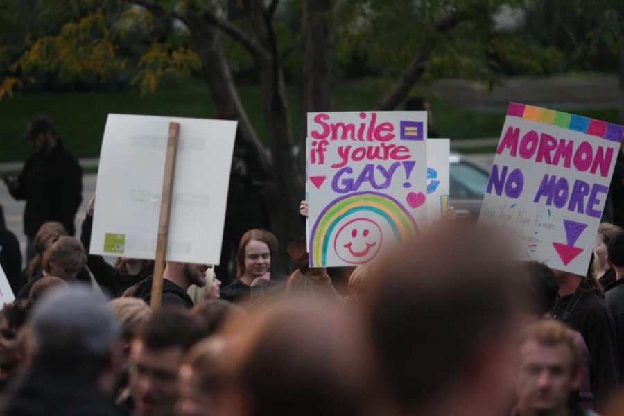 Members of the gay community hold up signs protesting a General Conference address from Boyd K. Packer and the Church of Jesus Christ of Latter Day Saints position on homosexuality. (Photo by Richard Payson | The Daily Utah Chronicle)
