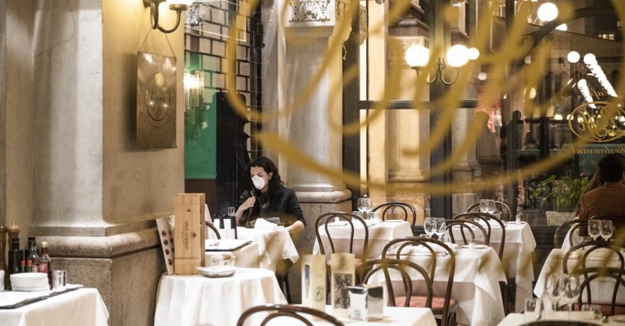 A tourist wears a protective mask at Biffi Restaurant in Galleria Vittorio, Milan, amid coronavirus fears. (Photo by Valeria Ferraro | Courtesy Getty Images)