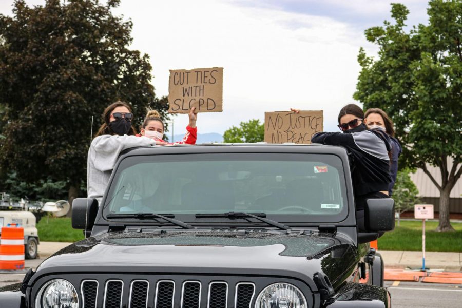Right, Alumni Xenia Maritsa, Natalie Griswold, Jessica Arthurs and Tara Arthurs sit on their jeep while listening to speaker at the caravan protest in Salt Lake City on June 6, 2020.