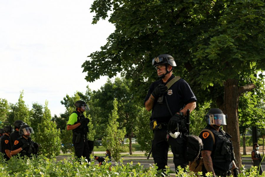 (Ivana Martinez | Daily Utah Chronicle) Salt Lake City police officers look at protesters gather at the Public Safety Building in Salt Lake City on Monday, June 1, 2020.