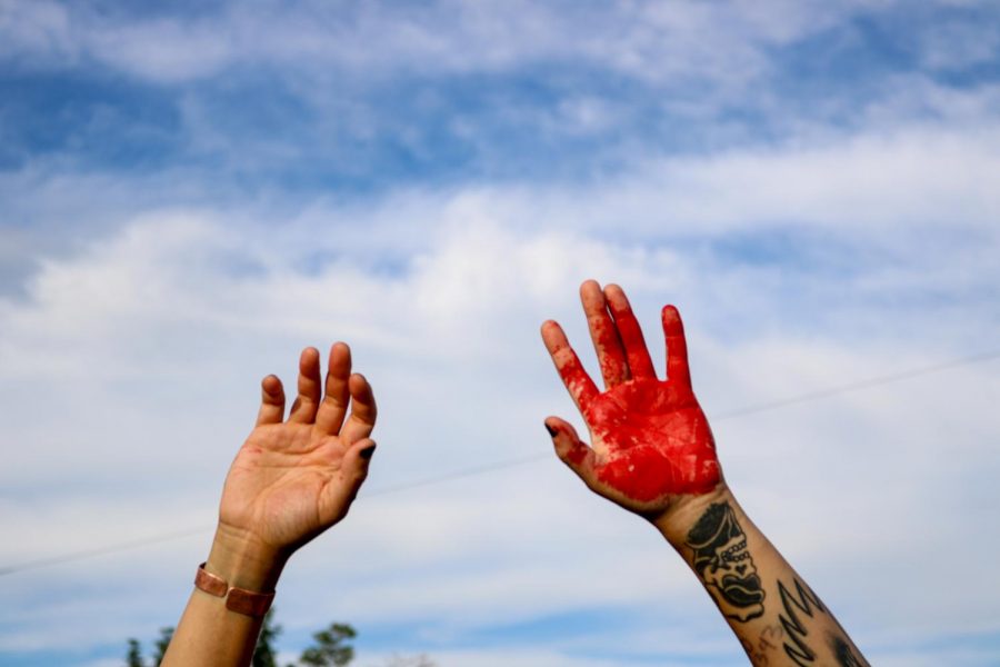 Protesters paint the streets red, to illustrates all the blood that has been spilled by the police at the District Attorney’s Office in  Salt Lake City on June 27, 2020. (Photo by Ivana Martinez | Daily Utah Chronicle) 
