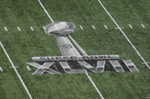 The NFL logo for Super Bowl 47 is seen on the field, in New Orleans, February 3, 2013. (Image via WikiMedia Commons)