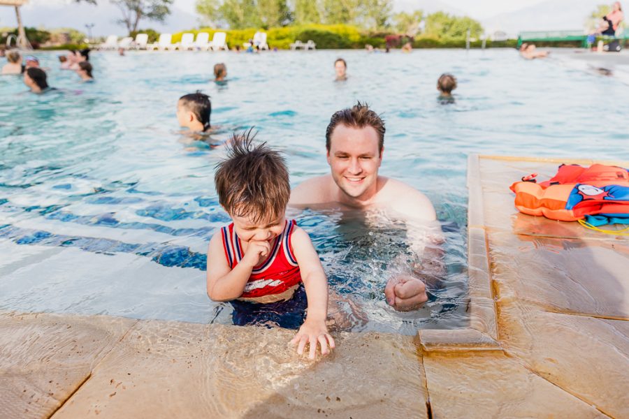 Ashton and Jordan Peterson enjoying the water at Hot Springs Pool in Saratoga Springs, UT on May 29, 2021. (Photo by Silvana Peterson | Daily Utah Chronicle) 