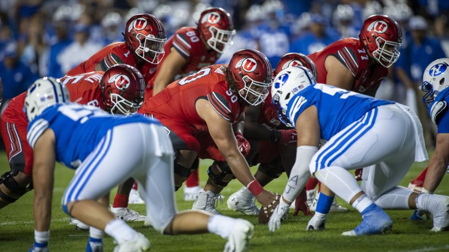 University of Utah junior offensive lineman Orlando Umana (50) snaps the ball during an NCAA Football game vs. Brigham Young University at LaVell Edwards Stadium in Provo, Utah on Thursday, Aug. 29, 2019. (Photo by Kiffer Creveling | The Daily Utah Chronicle)