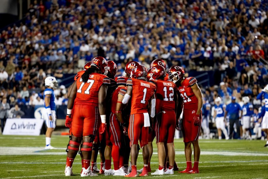 University of Utahs offense in the huddle during the game against the BYU cougars at LaVell Edwards Stadium in Provo, UT on Sept. 11, 2021. (Photo by Jack Gambassi | The Daily Utah Chronicle).
