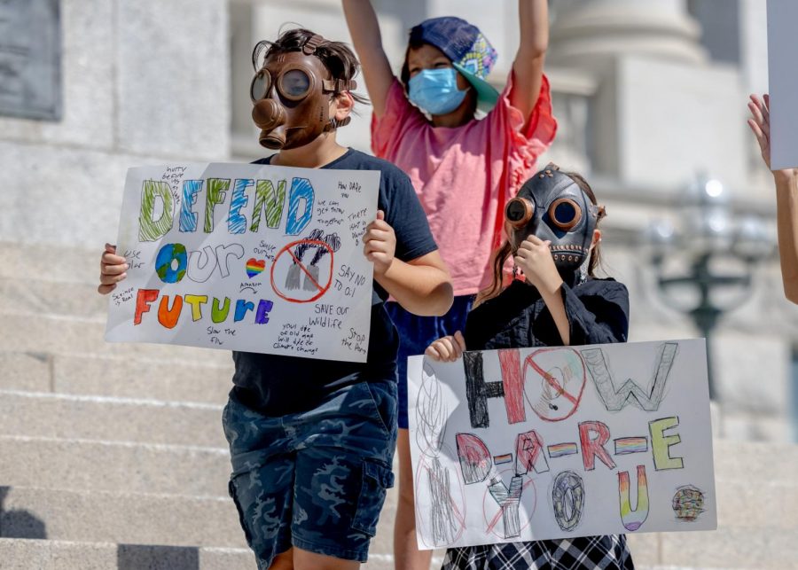 Two young protestors stand on the Utah State Capitol steps as part of the Global Climate Strike on Sept. 24, 2021. (Photo by Jack Gambassi | The Daily Utah Chronicle)