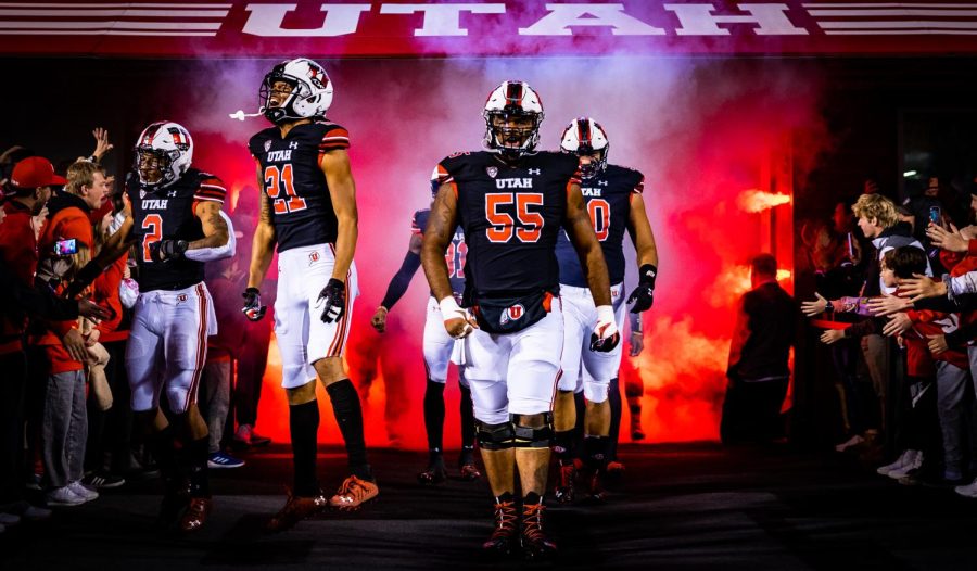 Junior center Nick Ford and junior wide receiver Solomon Enis walking along side running back Micah Bernard out of the tunnel at the game against Arizona State in Salt Lake City on Oct. 16, 2021. (Photo by Jonathan Wang | The Daily Utah Chronicle)
