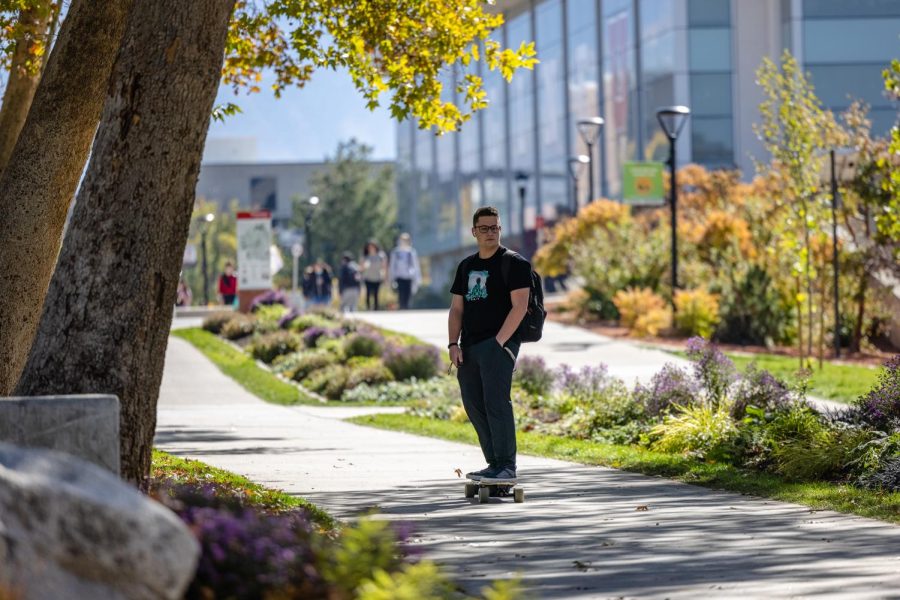 A student who rides a skateboard in the campus of University of Utah in Salt Lake City, Utah, on October 21st, 2021. (Photo by Xiangyao Axe Tang | The Daily Utah Chronicle)