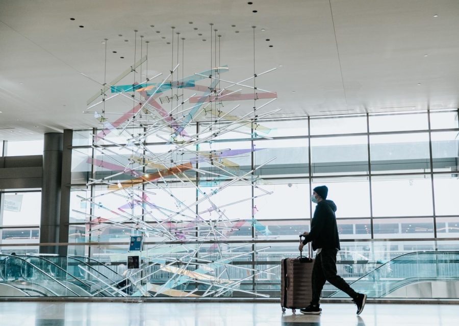 Passenger walks by the Gordon Huether art piece at the Salt Lake International Airport on Tuesday, Jan. 25, 2022. (Photo by Rachel Rydalch | The Daily Utah Chronicle)